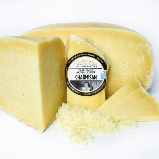 A block of aged Parmesan cheese with a label and grated cheese.