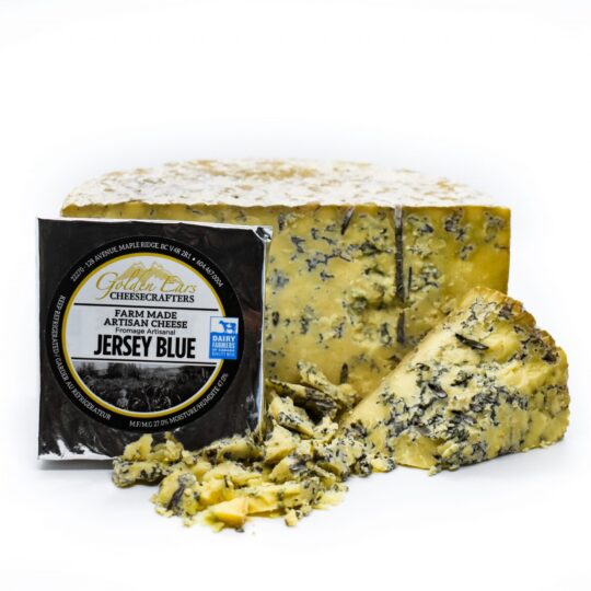 A block of Jersey Blue cheese with a wedge cut out, placed on a white background.